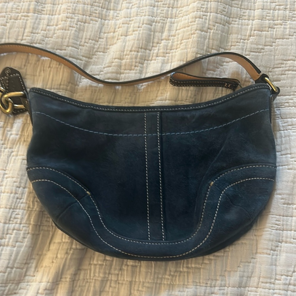 Small blue suede coach purse.